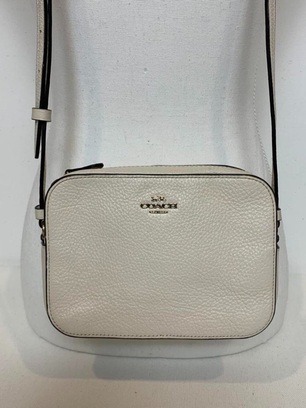 White refined pebble leather Coach
